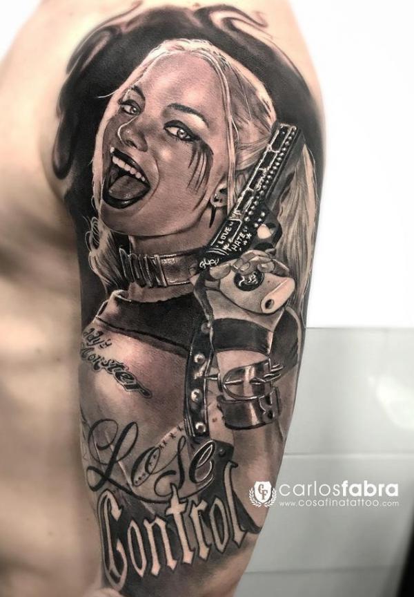 Realistic Harley Quinn with a gun half sleeve tattoo