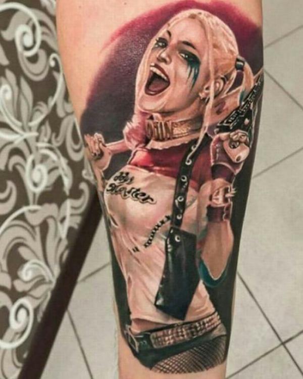 Realistic Harley Quinn with bat tattoo forearm
