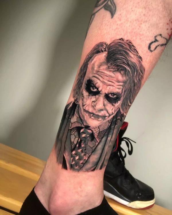 Realistic Heath Ledger Joker leg tattoo