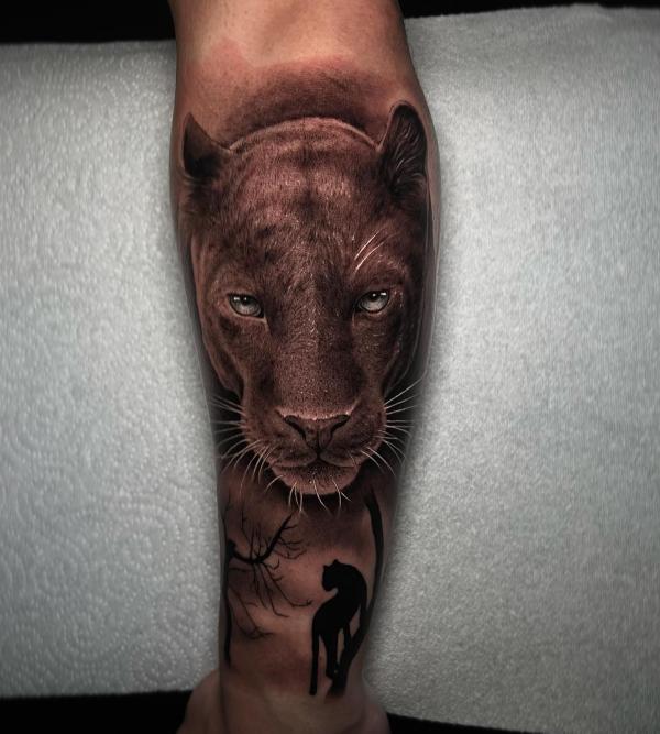 Realistic black panther calf tattoo