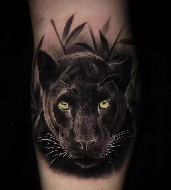 Realistic panther heand calf tattoo