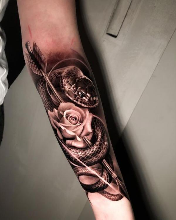 Realistic snake with arrow through a rose tattoo