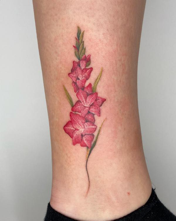 Red gladiolus above ankle tattoo