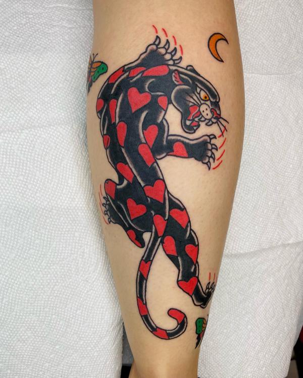 Red heart black panther tattoo on calf