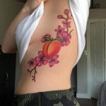Red peach branch with flowers and peach tattoo
