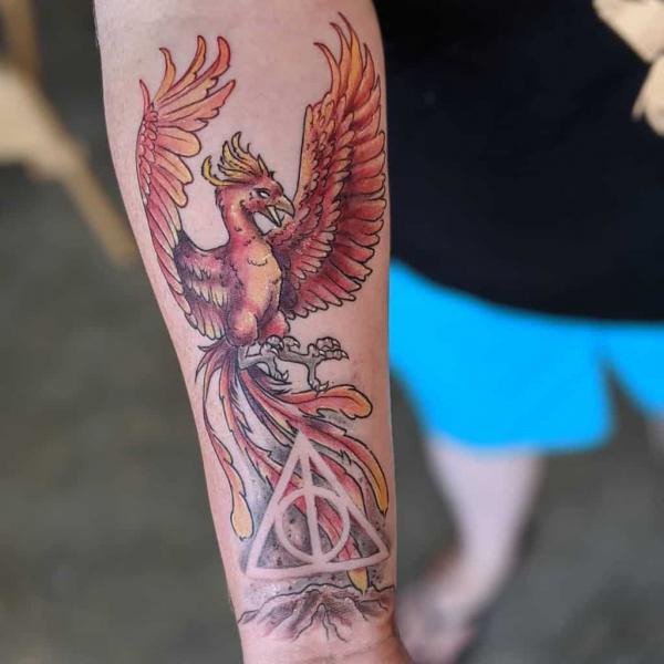 Red phoenix and deathly hallows tattoo