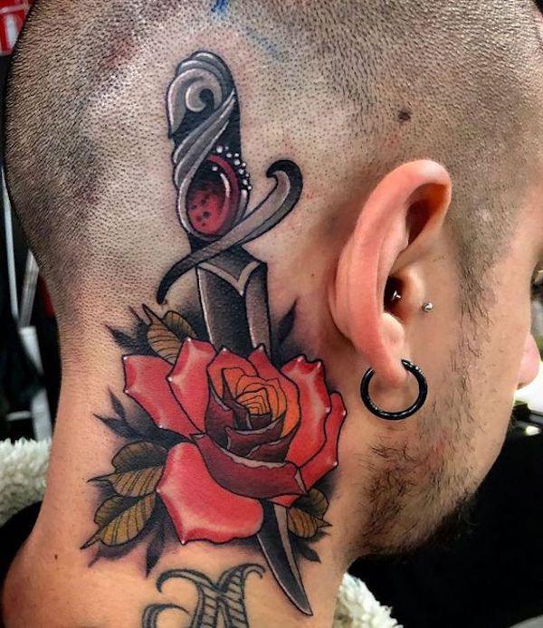 Rose with dagger neck tattoo