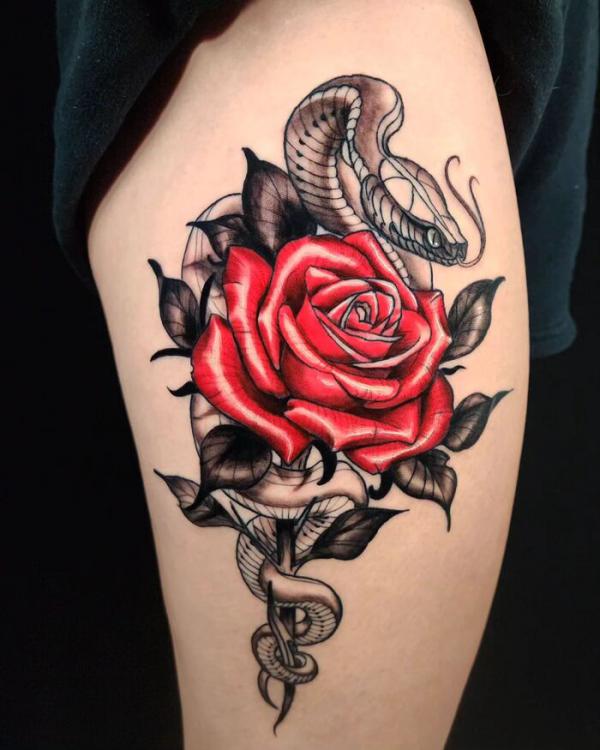 Rose with snake thigh tattoo