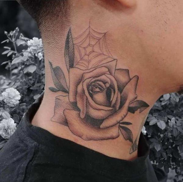 Rose with spider web tattoo on the side of neck