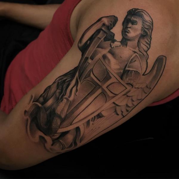 Saint Michael fighting snake half sleeve tattoo
