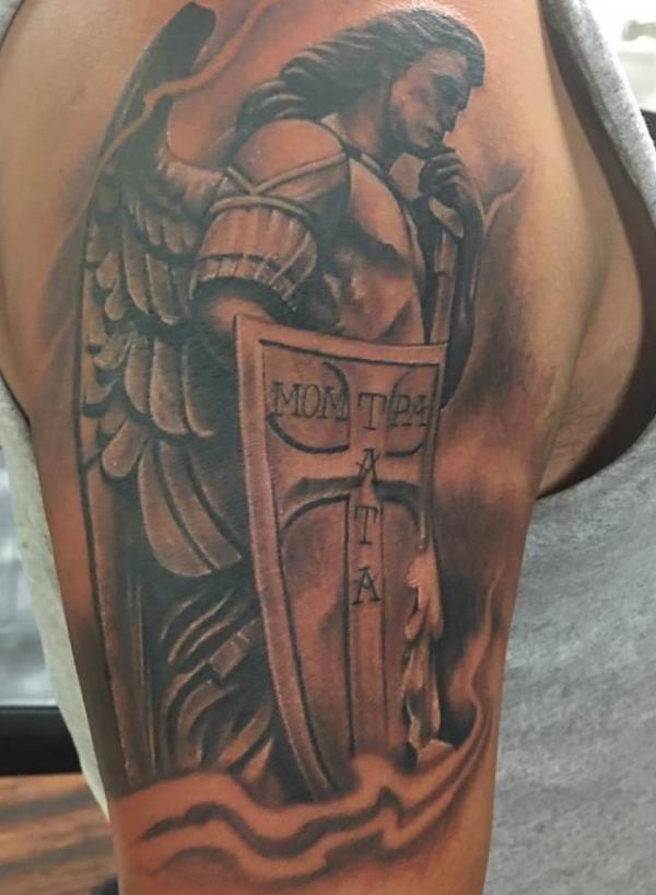 Saint Michael with shield half sleeve tattoo