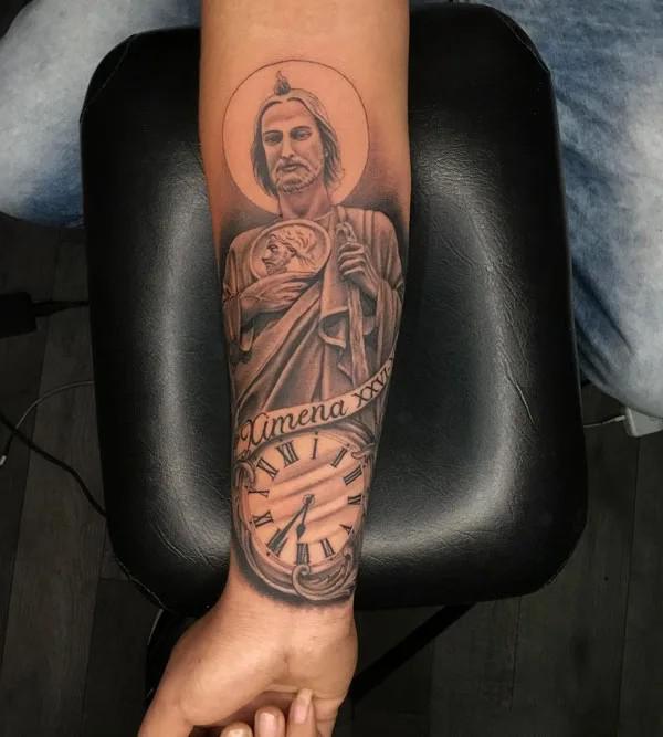 San Judas and clock forearm tattoo