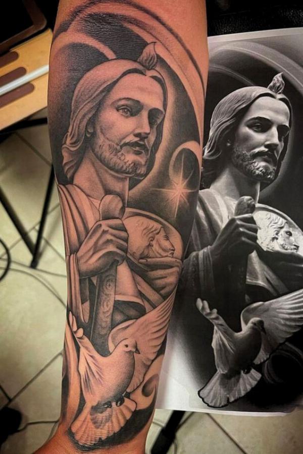 San Judas and dove tattoo forearm