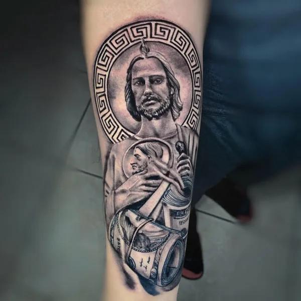 San Judas and money forearm tattoo black and grey