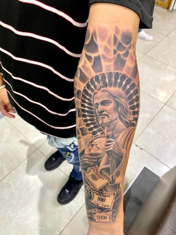 San Judas and money inner forearm tattoo 1