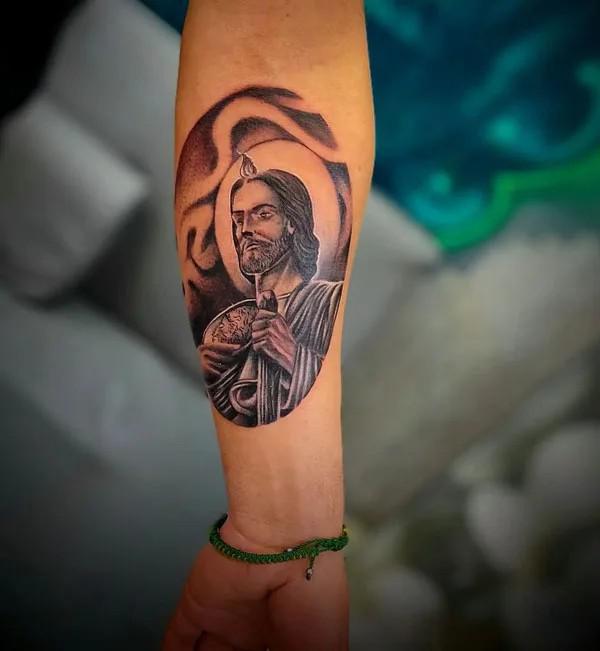 San Judas portrait forearm tattoo