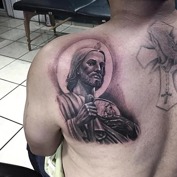 San Judas tattoo on shoulder blade