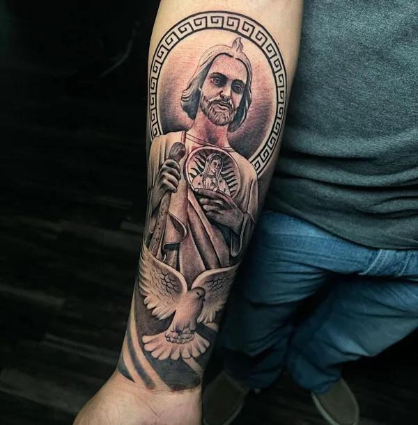 San Judas with dove tattoo on inner forearm