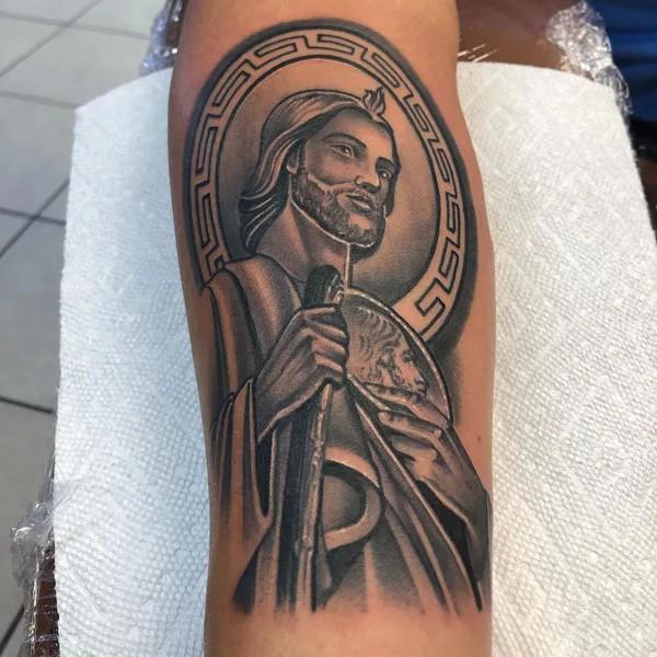 San Judas with greek key calf tattoo