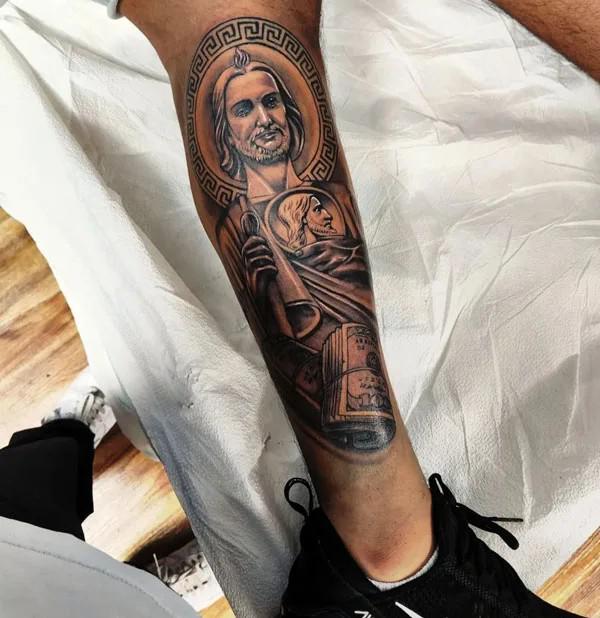 San Judas with mony lower leg tattoo