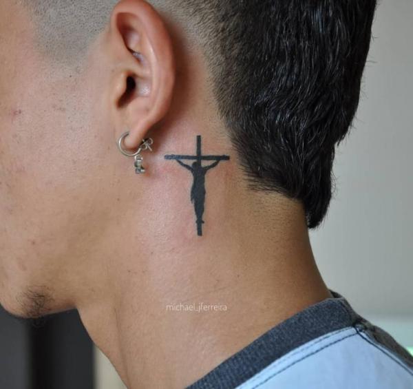 Silhouette cross tattoo with jesus behind the ear