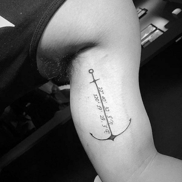 Simple anchor with coordinates tattoo on bicep