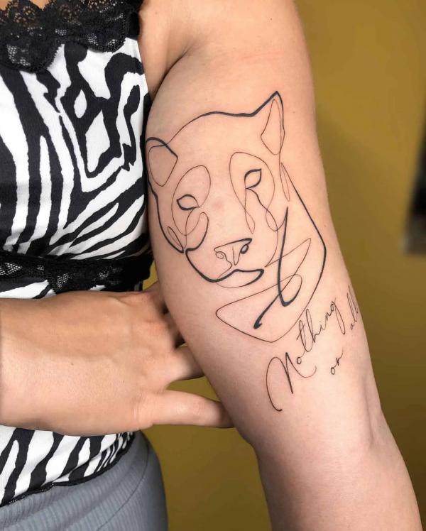 Simple panther line work tattoo with words Nothing at All