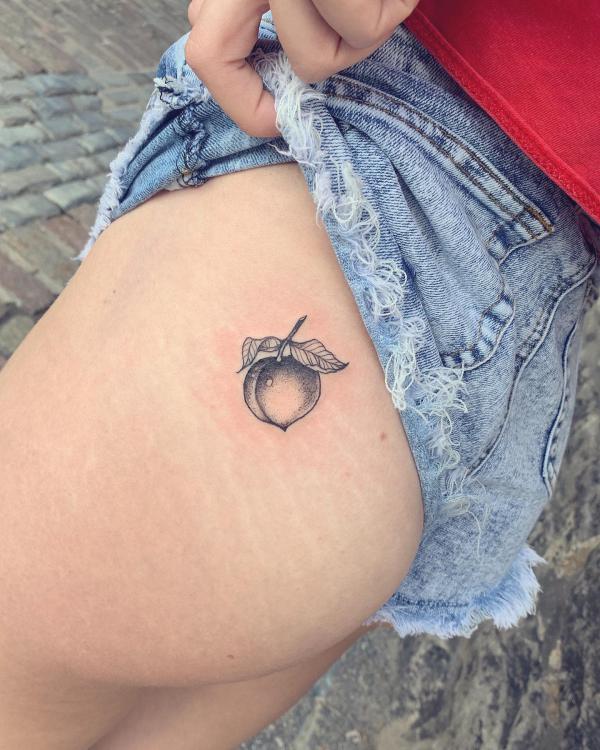 Single black and grey peach hip tattoo