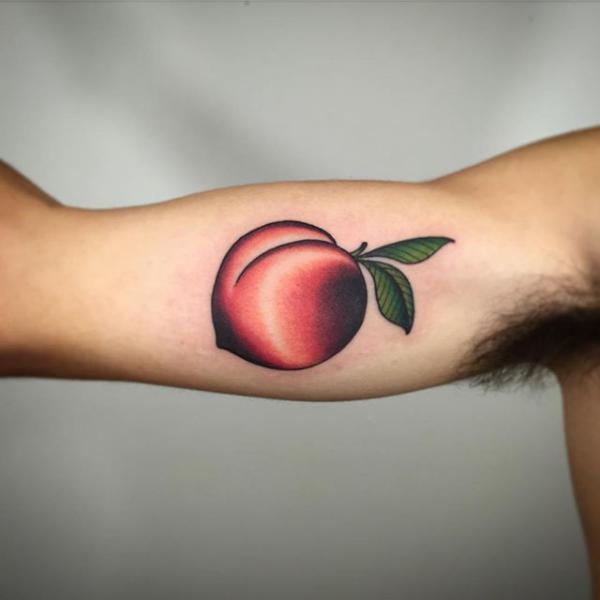 Single peach bicep tattoo