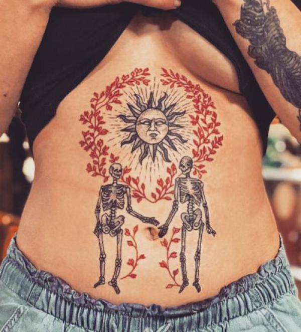 Skeleton lovers with sun stomach tattoo