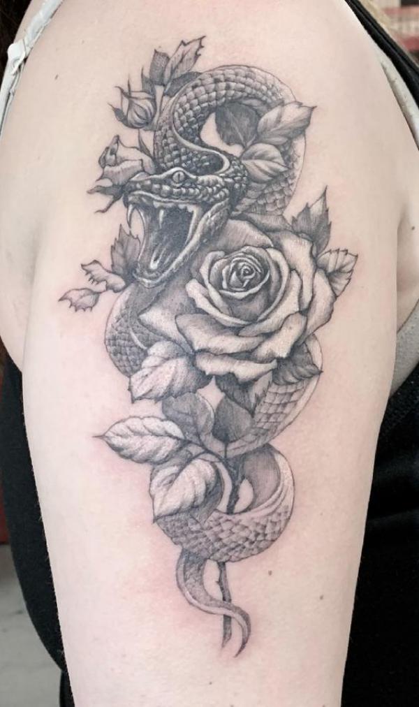 Sketchy snake and rose half sleeve tattoo