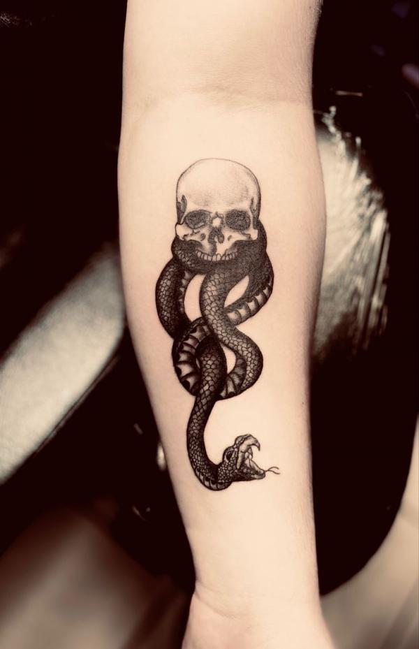 Small Black and white death eater tattoo forearm