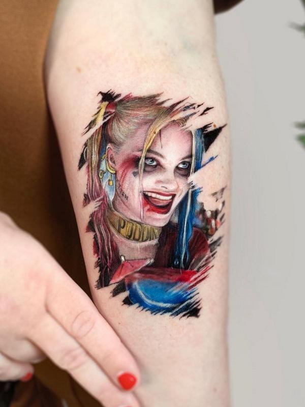 Small Harley Quinn upper arm tattoo