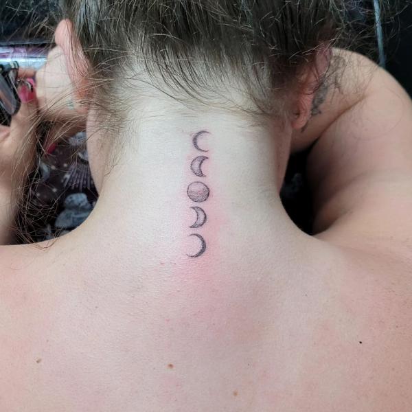 Small Moon phases back neck tattoo