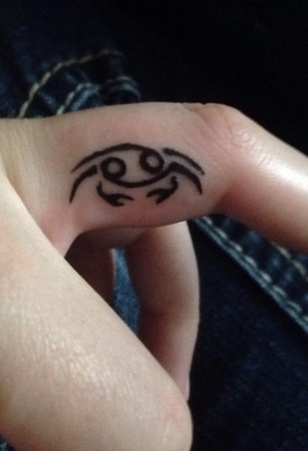 Small Zodiac cancer crab side finger tattoo