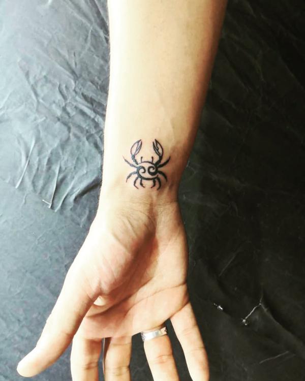 Small Zodiac cancer crab wrist tattoo