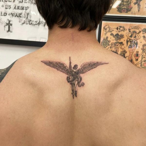 Small angel michael upper back back tattoo