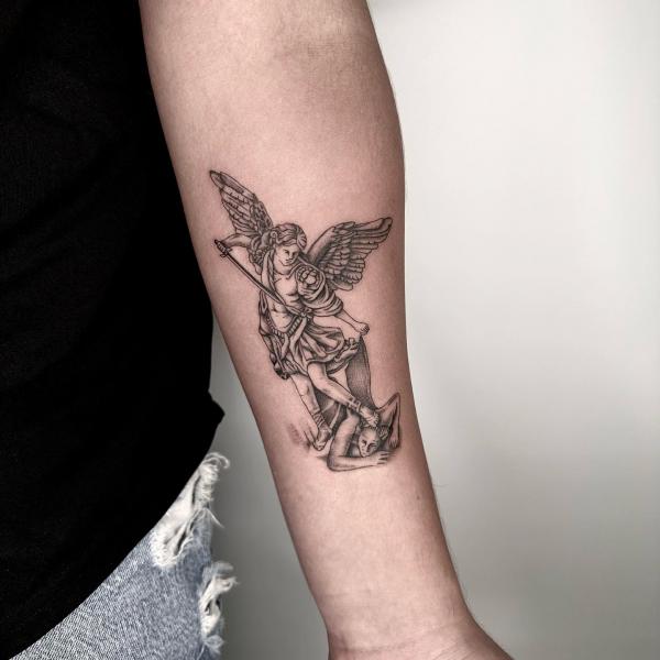 Small archangel michael tattoo on inner forearm
