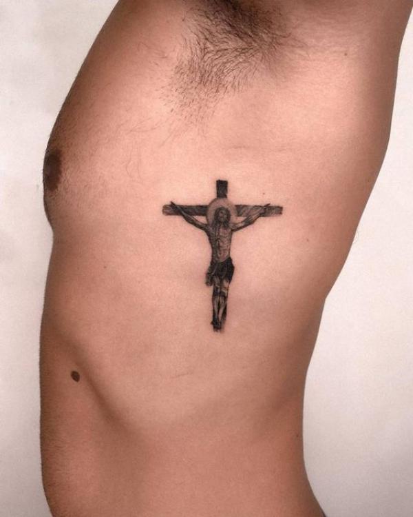 Small cross tattoo with jesus on side