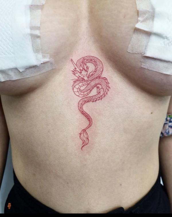 Small red dragon stomach tattoo