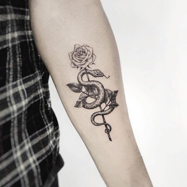 Small rose and snake forearm tattoo