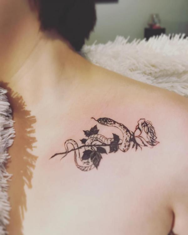 Small snake and rose tattoo clavicle