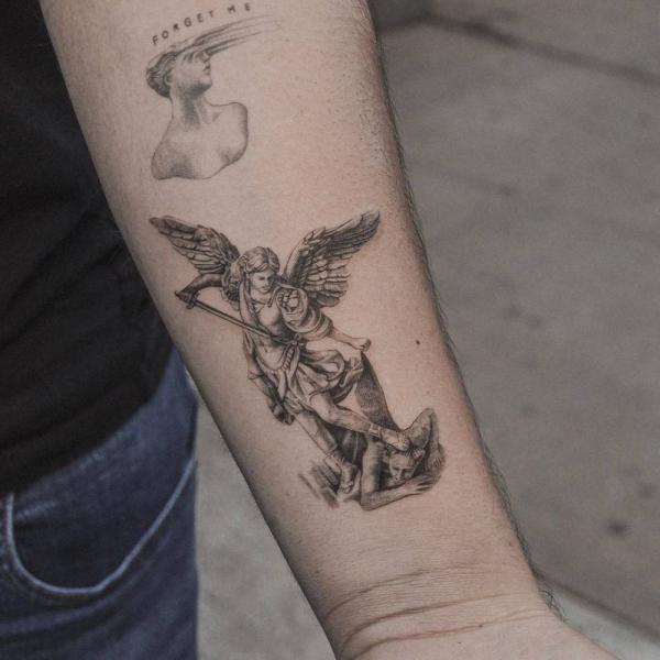 Small st michael slaying the devil tattoo