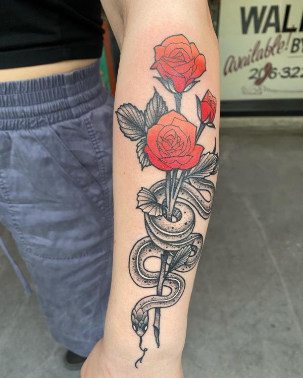 Snake and rose outer forearm tattoo