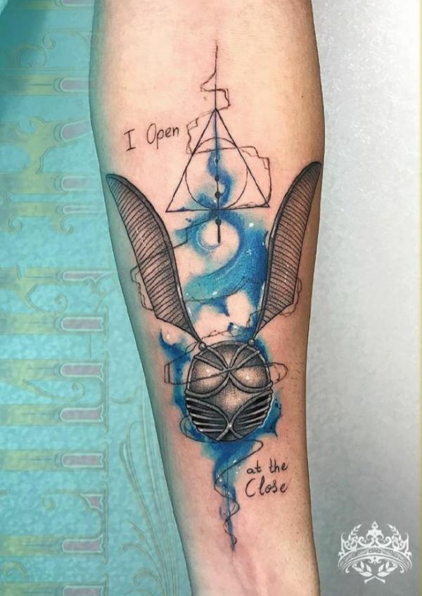 Snitch and deathly hallows forearm tattoo with the quote I open at the close