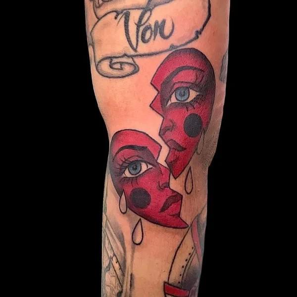 Spliting broken heart tearful face tattoo traditional