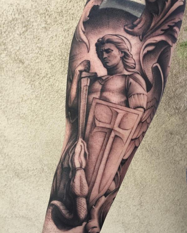 St Michael fighting snake forearm tattoo