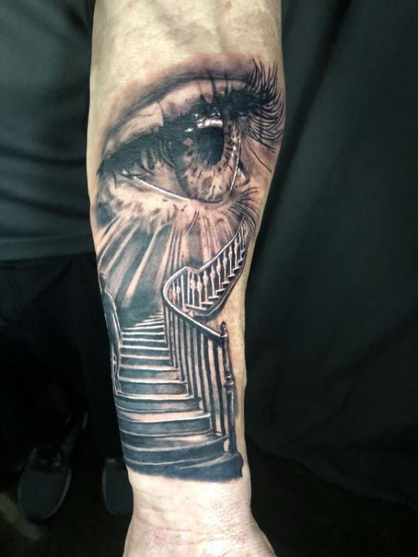 Staircase to heaven with realistic eye tattoo