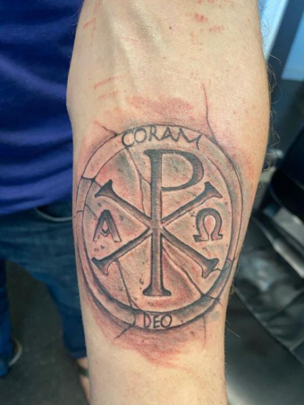 Stone Chi Rho tattoo with words Coram Deo