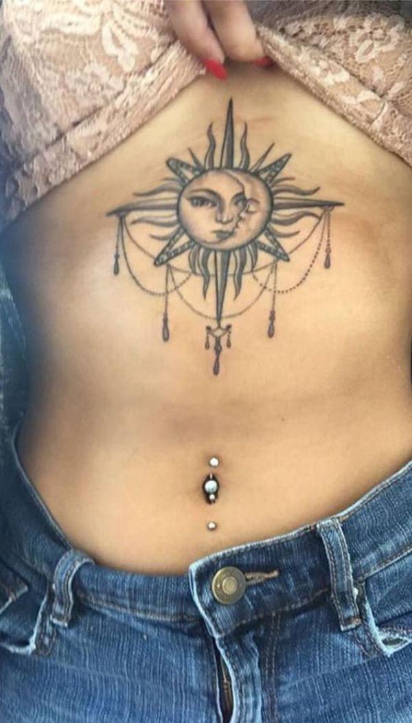 Sun and moon face stomach tattoo